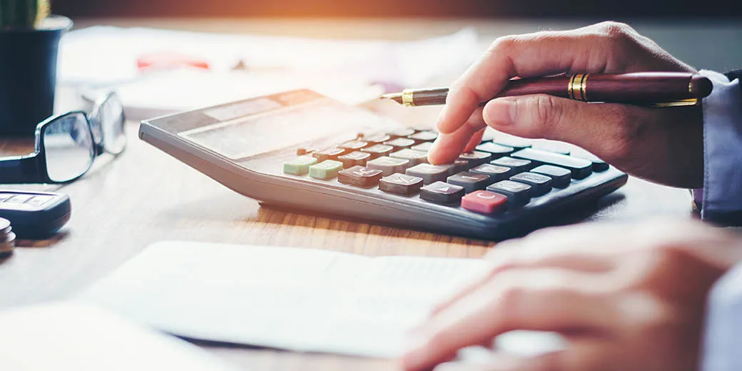 Businessman's hands with calculator and cost at the office