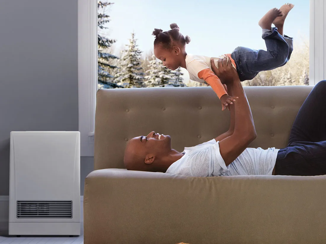 father playing with his daughter on the couch